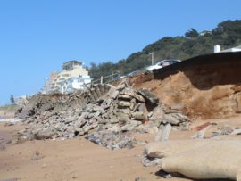 The damage done to the walkway and road at eMdloti.
