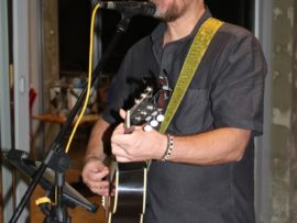 South African singer, songwriter and guitarist John Ellis performing at Mr Nel's farewell.