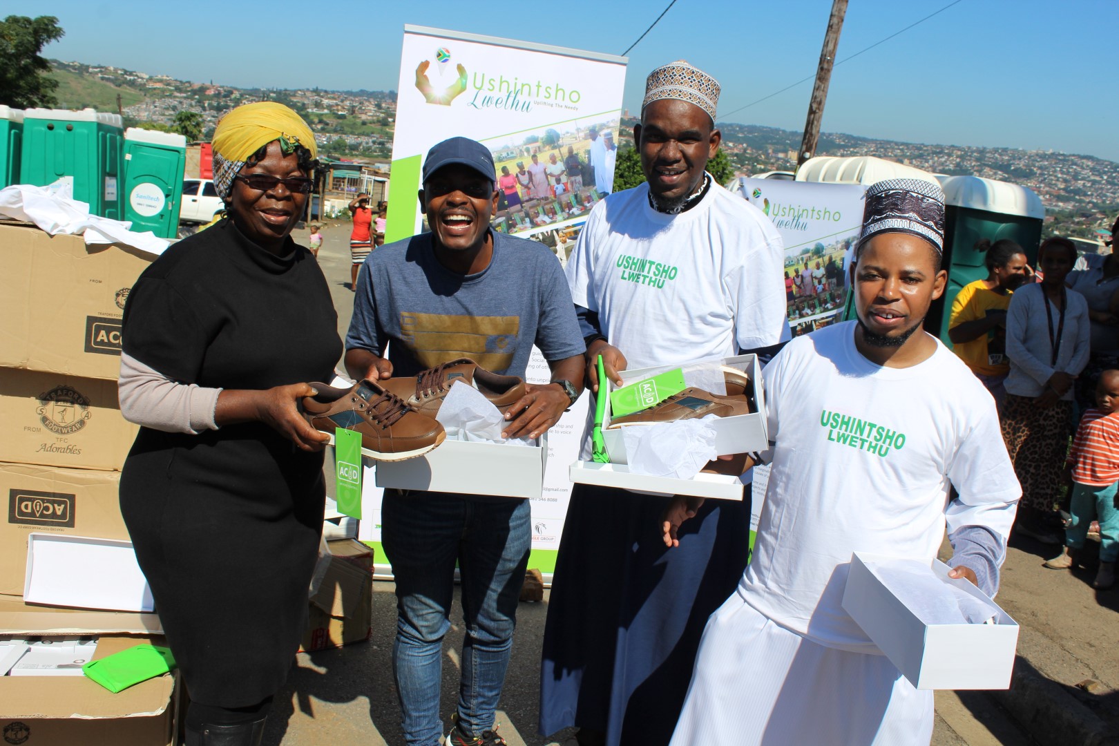 Phindile Ndlela and Innocent Mathaba of the Siyathuthuka Informal Settlement with some of the 150 pairs of shoes donated by Habeeb Milanzi and Dawood Frickra from the NPO, Ushintsho Lwethu (Our Change).