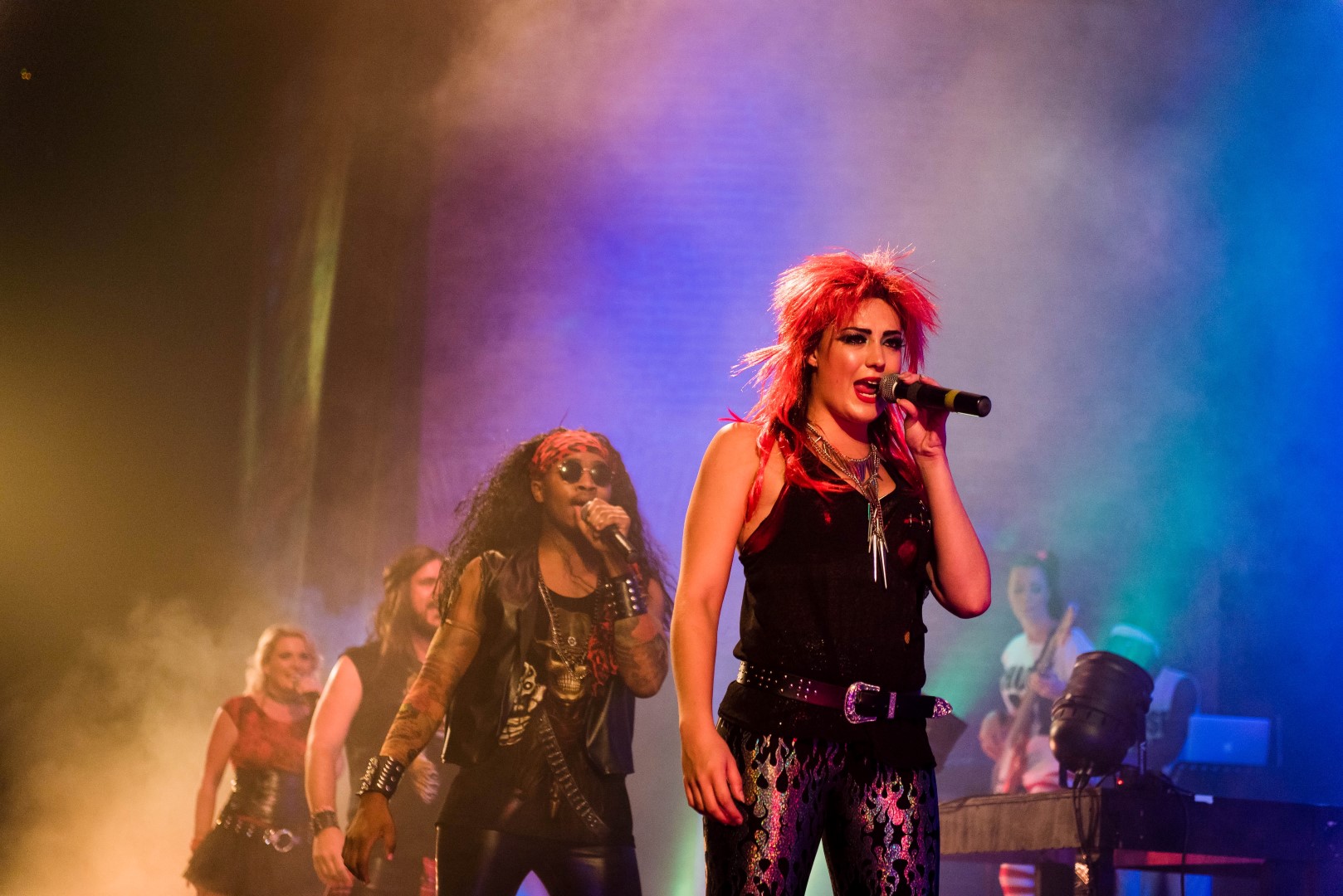 Aimee Gleeson in front of Kevin Meduna performing in That 80’s Show.