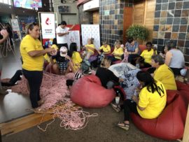 Some of the volunteers rolling yarn.