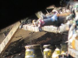 Jars of pickles remain on the scorched shelves.