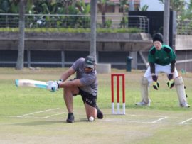 Hollywoodbets Dolphins player, Vaughn van Jaarsveld, attempts a sweep shot in the friendly game against the KZN Blind Cricket team with Senzo Luthuli keeping a watchful eye behind the stumps.