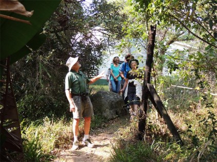 Ivungu conservancy member Dave Halle, who led the Hibiscus Coast Rotary Club walk, points out interesting features of the walking trail.