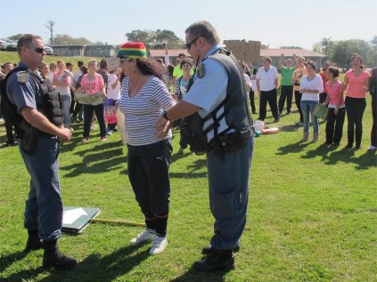 Warrant Officer Gerhard Prinsloo (left) and Warrant Officer Johan Maree playfully 'arrest' Adrie Keyser from Suid Natal High.