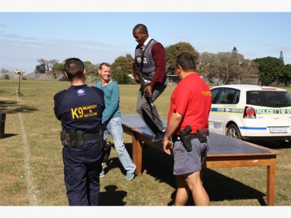 Grade 10 Port Shepstone High pupil Banele Zithumane gets to experience what it feels like to run while wearing a heavy, bullet-proof vest' and carrying a firearm. Police explained that, although it is difficult to run with a bullet proof vest, it can save their life.