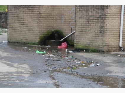 Thousands of litres of water flow from this pipe at the Dick King parking area in Port Shepstone. This water is now being used to wash cars in the parking area.