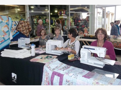 Quilters' Guild members (from left) Stienie Faber, Charmaine Grainger, Janet Cushway and Cynthia White, happily sewing lap quilts at the Southcoast Mall.