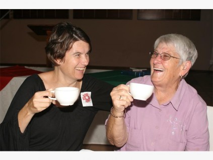 Pianist Tracy Taylor (left) and guest speaker Elize Scheepers toast Stonecroft Ministries with a cup of tea.