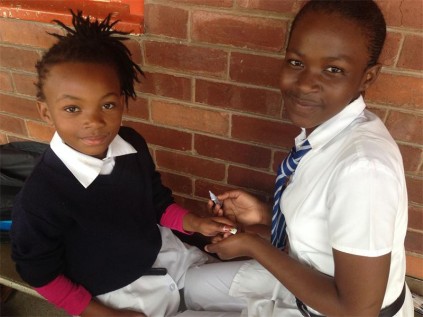 Applying the skills taught during her EMS lesson is PSP pupil Philisiwe Mbhele (right) from gr 7 with Ndovela Kokubonga of gr 4 enjoying her manicure.