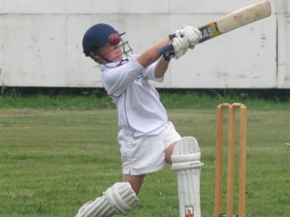 Reece Murray goes for broke while batting.