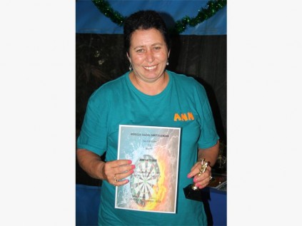 Ann le Roux of Car Wash Darts Club receives an award for scoring 180.