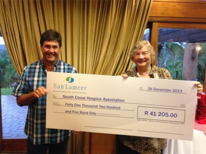 Andries Brink (San Lameer Country Club president) hands over a cheque to Di van Dyk (South Coast Hospice CEO) at the recent San Lameer President's Cup prize-giving.