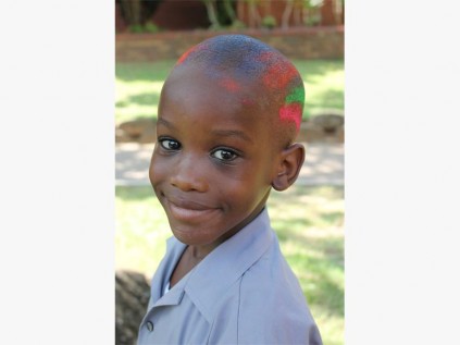 Kusasa Mcwane has his head sprayed for a good cause. 