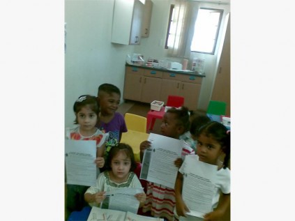 Excited about getting signatures for water pledges are al Hudaa pre-schoolers (from left) Wafaa Ebrahim, Dwyn Rangasamy, Ammarah Khan (seated), Jasmeen Cele and Rihanna Allee.