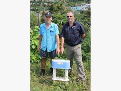 Fred Lauterbach (left) and AfriForum's Chris Fourie show the illegal water meter installed on Mr Lauterbach's property.