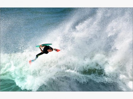 A bodyboarder takes to the air.