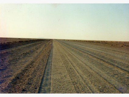 A long, straight road through the sands of Namibia.