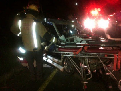Paramedics prepare to take the injured driver to hospital.