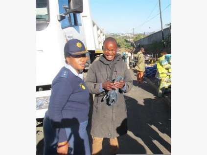 Major General Thembi Ndlovu talks to a community member at the taxi rank.