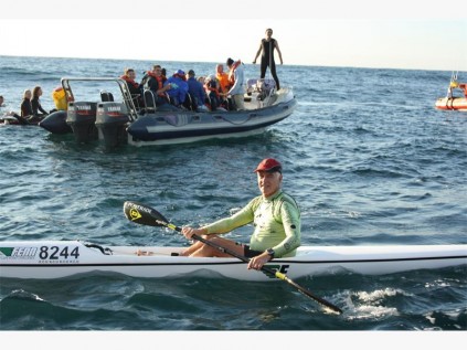 Paddler Mike Halliday (front) and C Freak Charters meet up at the shark nets for the event.