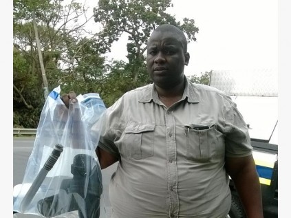 Sergeant Thabang Mofokeng with stolen property.