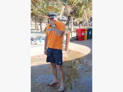 Robbie Carelse from Benoni holds his nose while walking through the stinky water.