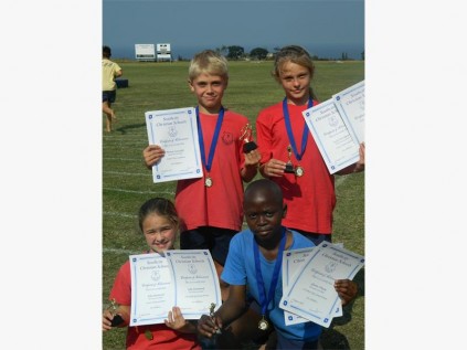 Pupils (back, from left) Thomas Constable  (senior victor ludorum), Tayla van Rooyen (senior victrix ludorum), (front) Ella Drummond (junior victrix ludorum) and Qhama Nkume  (junior victor ludorum).