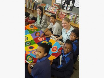 Fourth year students Natalie Timmermans (far left) and librarian Melanie Hurn (third from left) help gr 3 pupils (from left) Matthew Hendricks, Madhdiya Dada, Amahle Cele and Isabella Ogle finish off handmade tablecloths that each class will be raffling in the fourth term.