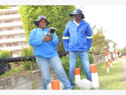 Ugu meter reader Phindile Khumalo (left) shows Ugu municipal manager DD Naidoo the ropes.