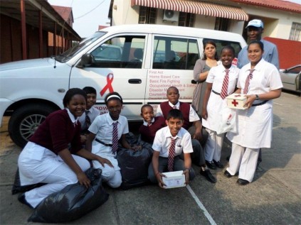  RA Engar pupils (from left) Sarah Motha, Ashendren Govender, Lathitha Nteyi,  Nhlanhla Ndwalane, Sonmga Jiba, teacher Nirupa Ramchander, Samukelisiwe Ngesi, Samishka Ramharak, Red Cross volunteer Edwin Ntusi and Rivash Rambharos (in front) at the handover of funds raised by the school.