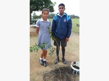 Pupils Micaela Palmer and Cameron Krishna proudly show off the indigenous tree planted for Arbor Day last week.