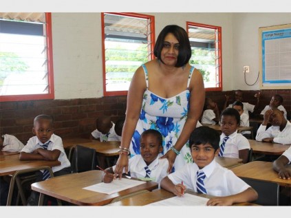 Working hard: PSP gr 1 teacher Malanie Moodley lends a helping hand to pupils.