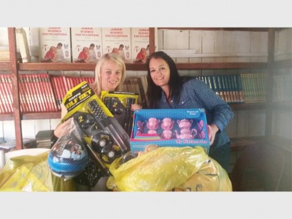 Hibberdene Academy teachers Karen de Lange (left) and Lara Baldrey sort out items donated to the school by the Shelly Beach Rotary Club. Impressively, both Karen and Lara swam and completed the Midmar Mile.