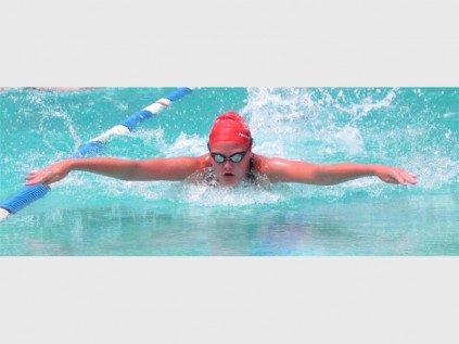 Samantha Labuschagne swims the 50 metre butterfly at the recent Creston College interhouse gala and eventually broke 5 records in her age category.