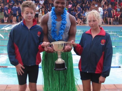Creston's Falcon house team captains Jamie Evans (left) and Theresa Kuhn flank head of Falcon, Qiniso Mazibuko holding the Interhouse trophy at the gala held at the school last week.