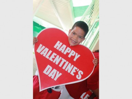 Aaron Hendricks helps put up decorations for St Valentine’s Day.
