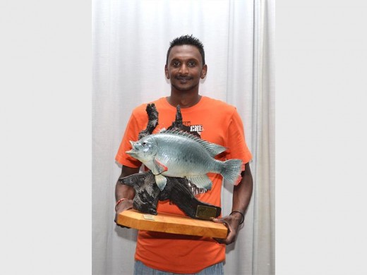 Trophy time: Yegan Gounden is pleased to have won first place for catching the biggest tilapia, weighing 2.15kg. PHOTO BY DELLA ROW PHOTOGRAPHY & DESIGN