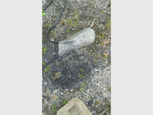 Danger: A live cable is seen covered with a plastic bottle near Mkholombe last Friday.