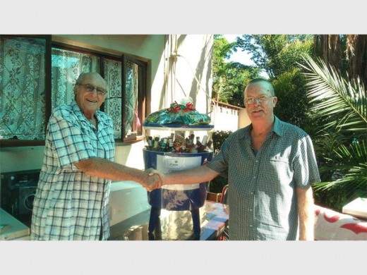 Deluxe hamper: Moth Brian Coward (right) congratulates fellow Moth John Dolby on being the lucky winner of the sumptuous hamper raffled at the recent Cinder City Moth Shellhole food, wine and brandy tasting festival.