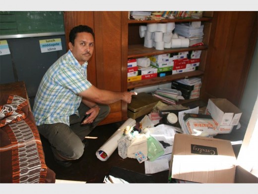 Deputy principal Tyrone Stephen, points out a classroom cupboard that was forced open and stationery removed. 