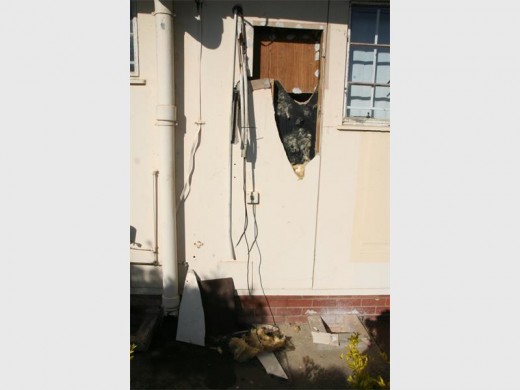 Criminals broke this prefab wall and gained entry into the kitchen and removed a microwave. 
