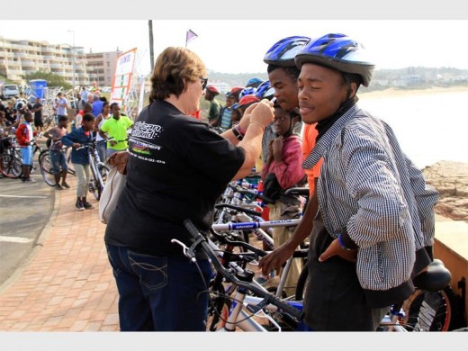Here we go: Mandie Stander assists her young riders in fitting their brand new helmets.