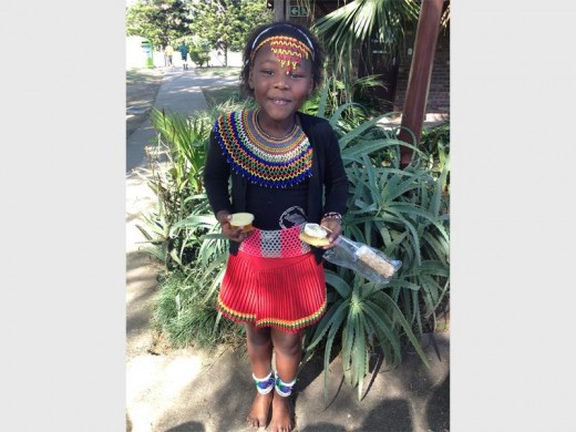 Dressed in her beautiful traditional outfit, Kwezi Shezi of Izotsha Primary had a good shopping trip to the cake stalls last week.