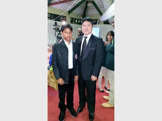 Atish Ghingai (left) was recently graded to black belt status by visiting world champion and karate maestro Murakami Manabu.