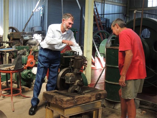Bill looks on as Len demonstrates the workings of one of the more obscure exhibits at the stationary engine museum.