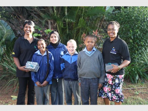 PSSP pupils (from left) Amishka Solomon, Nasreen Dindar, Owen Parker, Thabiso Mabaso presented funds collected by the school to Sagree Naicker (left) and Bathobile Chiliza from Child Welfare (right).