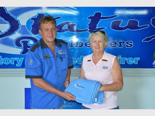 Grateful: Gerhard Steyn of Status Panelbeaters hands over a golf towel to Linda Rybicki.