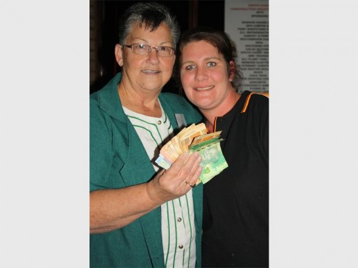 Show me the money: The big winners of the Construction Golf Day were South Coast Hospice. BT King (left) receives very welcome contributions from generous golfers collected by Donna Hardwick and her team at the Cole's Kitchen's hole.