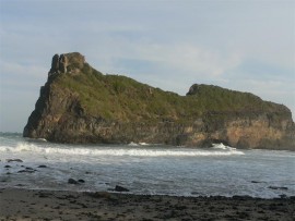 The offshore sandstone stack through which the waves have punched a hole. Or was it the sea people?